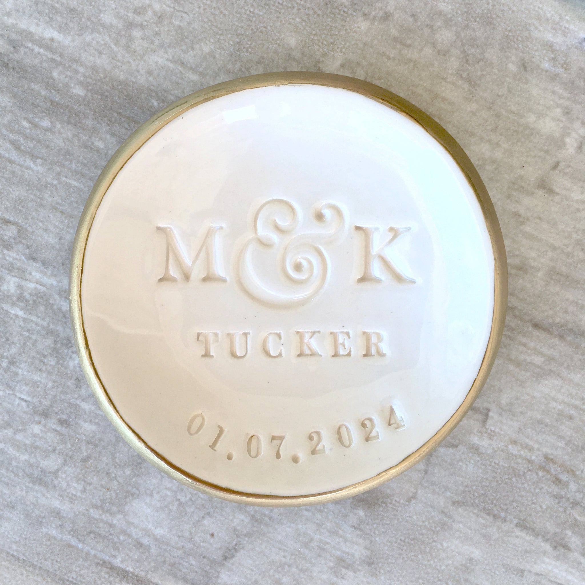 Handmade ceramic white gloss bowl with gold rim, smooth surface & typographic design of classic style letters & a date pressed in clay. Includes 2 name initials, a family last name and a date. Customized ring holder personalized weddings ring dish pottery anniversary gifts marriage or engagement gift for couple.