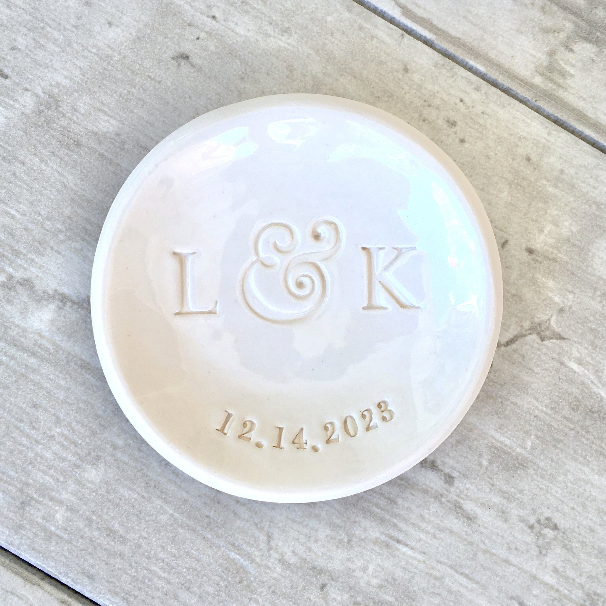 Modern minimalist handmade ceramic white gloss bowl on wood surface ideal wedding ring dish. Typographic design includes 2 hand engraved name initials & a date. Perfect wife anniversary present, jewelry trinket holder bowl, newlyweds distance gifts, Farmhouse decor tray small trinket holder, spouse husband wife ceremony milestone tray keepsake, daughter in law women birthday present, future mr and mrs bridal shower tray, home office desk accessory, tabletop trinket plate.