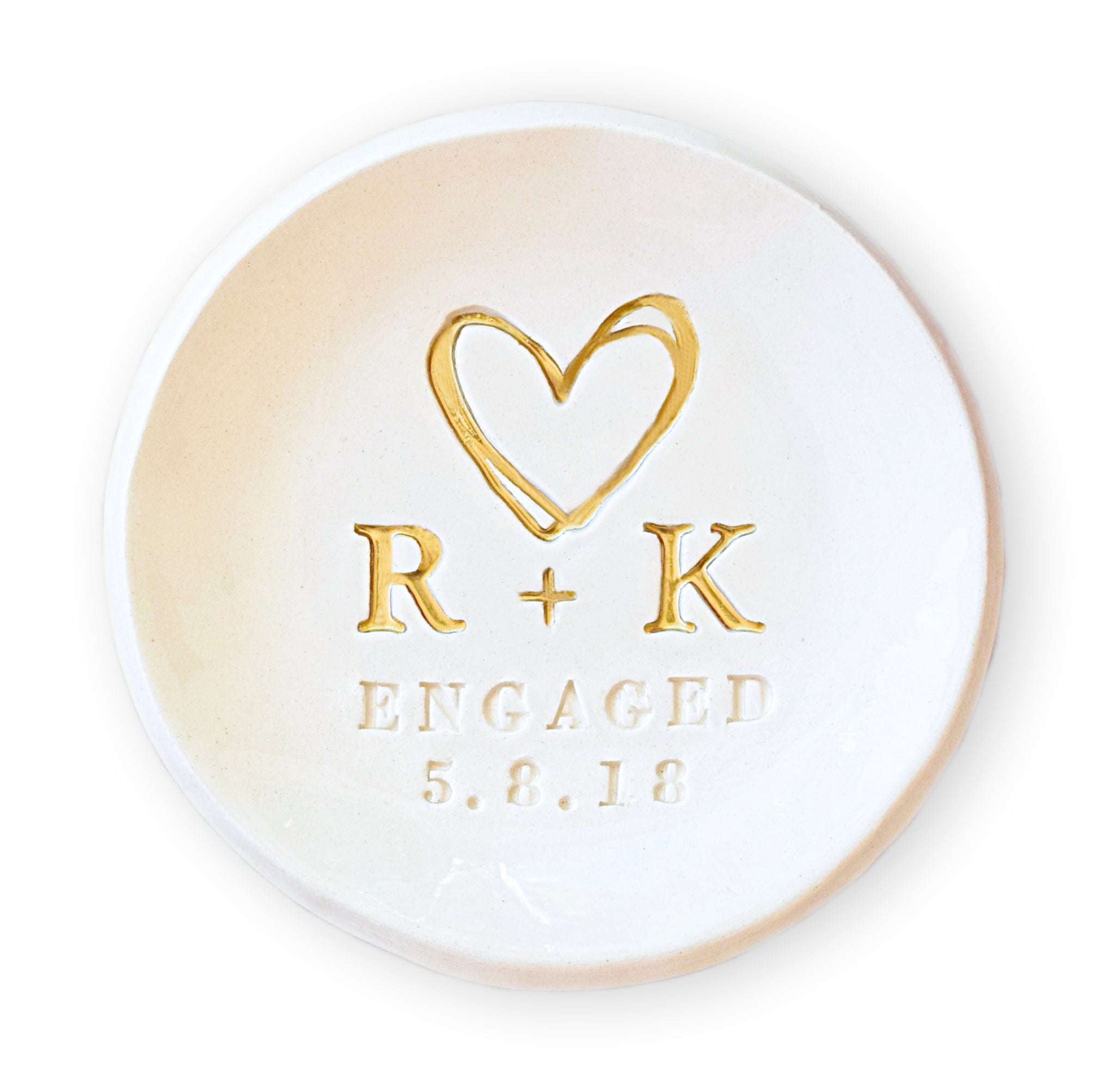 Handmade ceramic ring dish personalized with couple’s name initials and engagement date, features hand painted gold heart and initials, custom engagement gift for couple