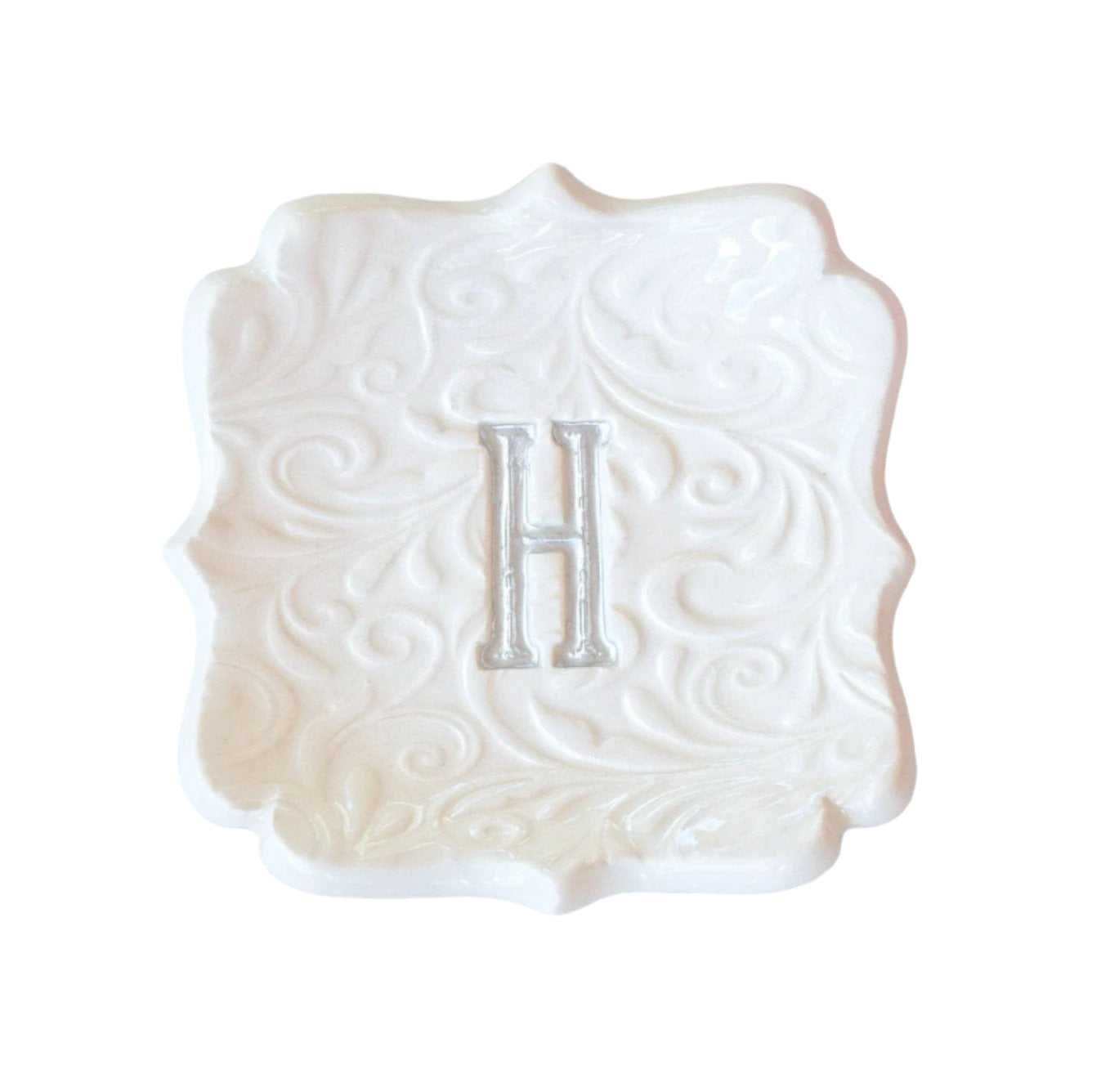 modern handmade ceramic ring dish personalized initial jewelry holder, fancy square tray with curvy scalloped sides, embossed floral swirl design surrounds engraved letter, letter painted silver, unique bride to be gift, wife anniversary gift 