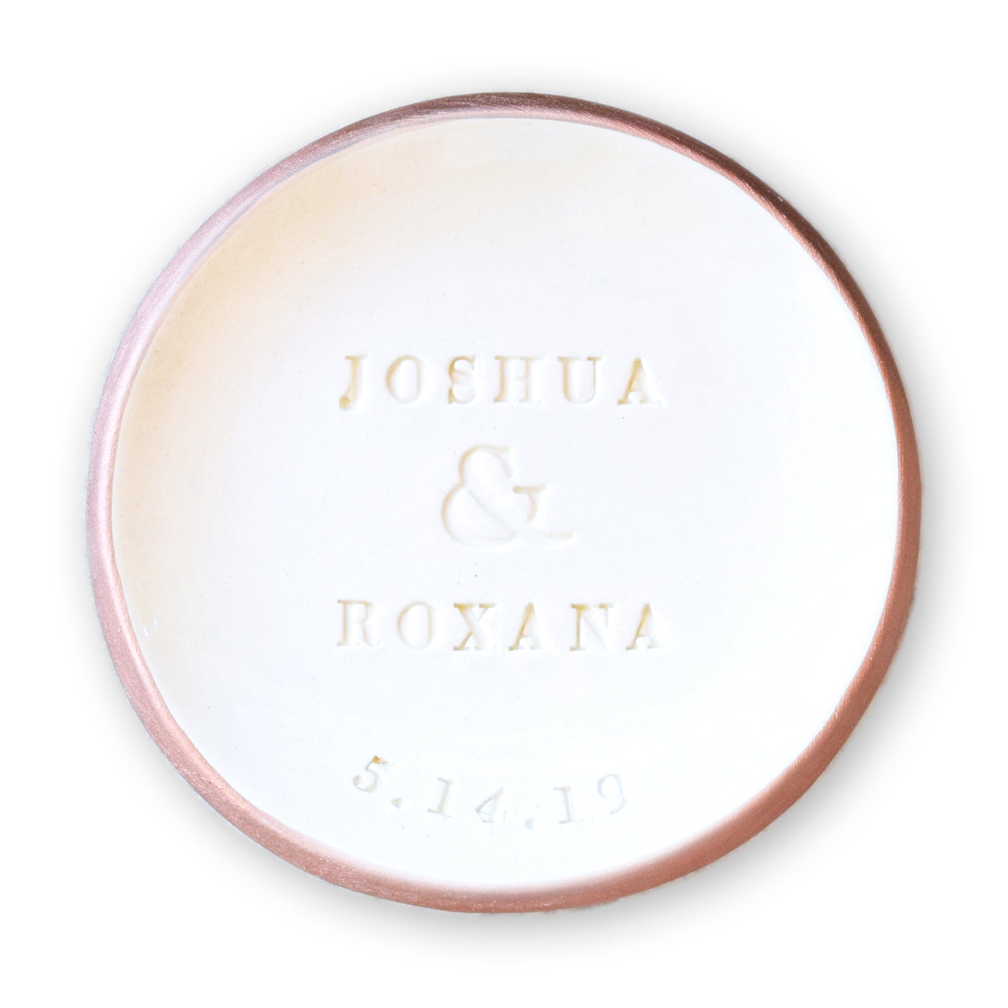 handmade ceramic ring dish features embossed names and date, hand painted rose gold trim white gloss finish bowl, personalize wedding ring holder couples wedding gift and heirloom anniversary keepsake. 
